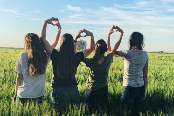 women forming heart gestures during daytime